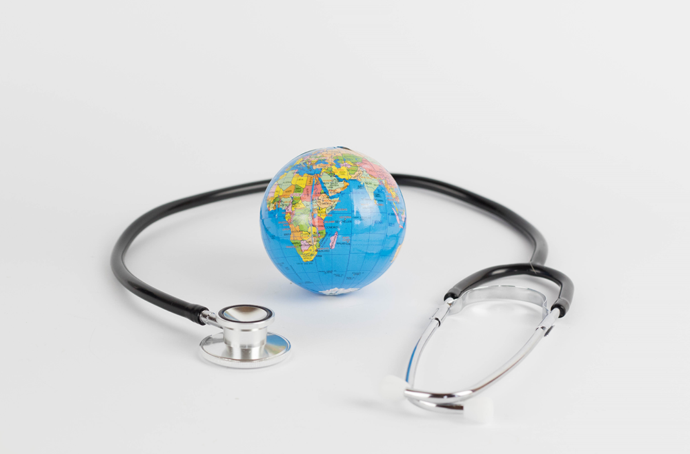 stethoscope around a tiny globe